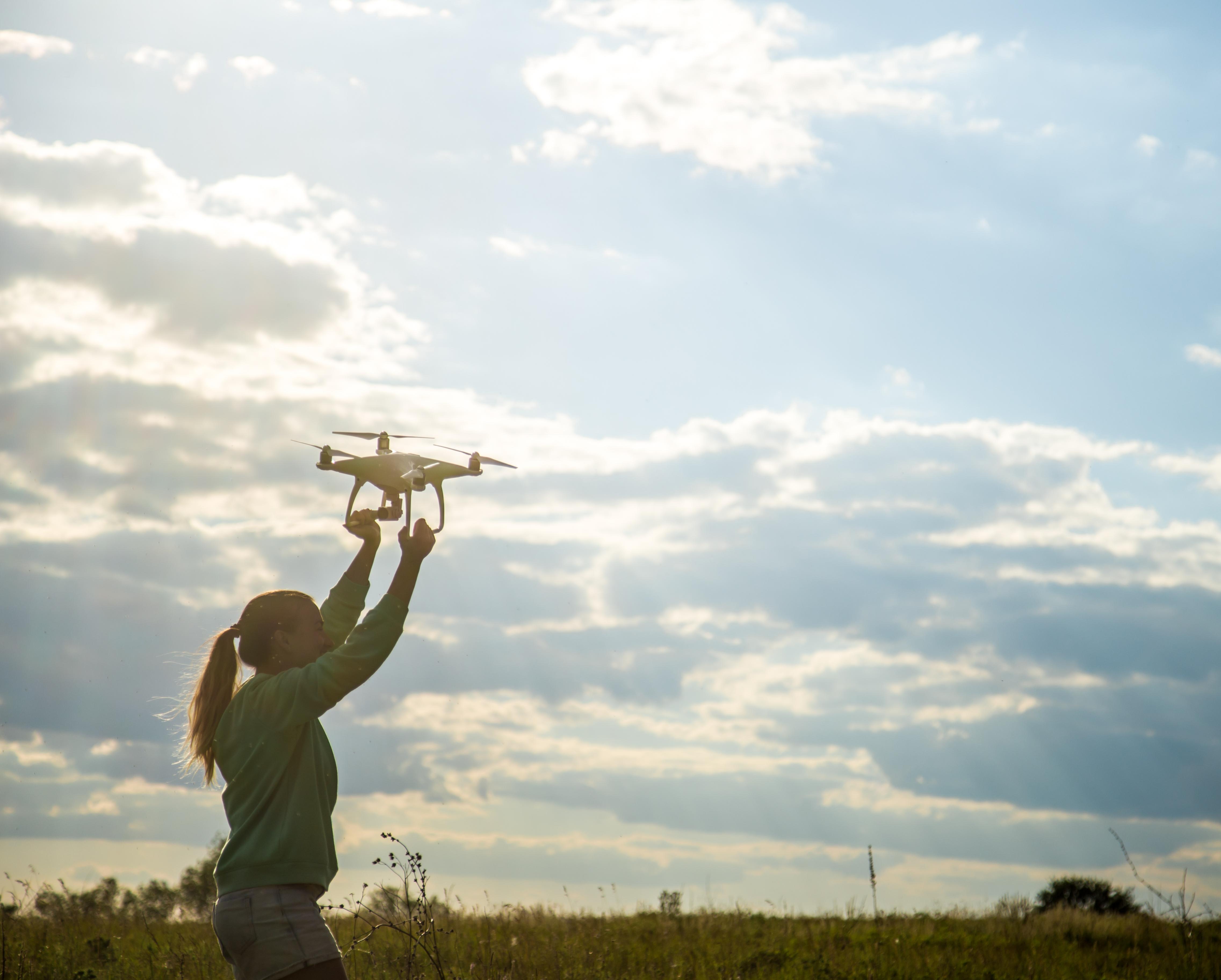 beautiful-girl-field-launches-drone-into-sky